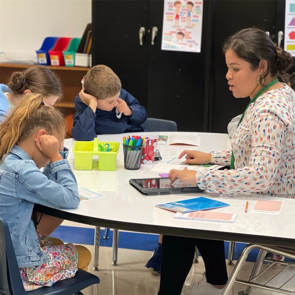  riela Oseguera, third grade DLI teacher, works with a small group.